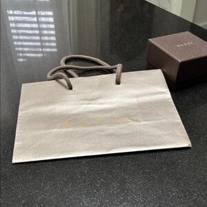 Gucci Shopping Bag and box with Gold Logo and Brown Rope Handles.
